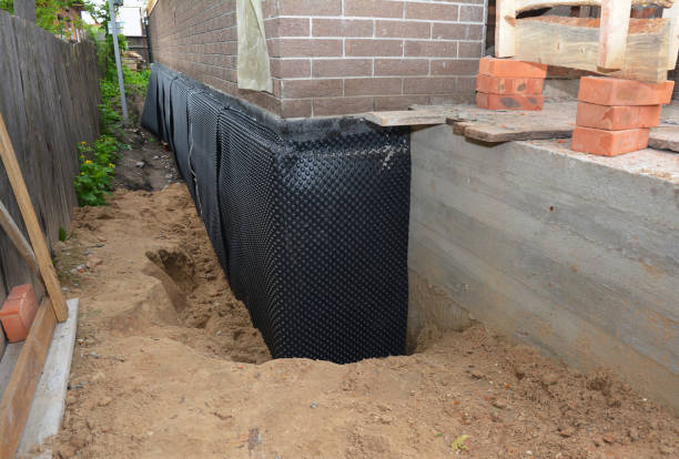 SJ Waterproofing Pros technician performing targeted Wet Basement Repair assessment in Whitehall, OH